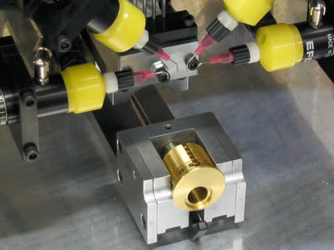 Automatic pin inserter system for inserting adhesive and pins into a lock