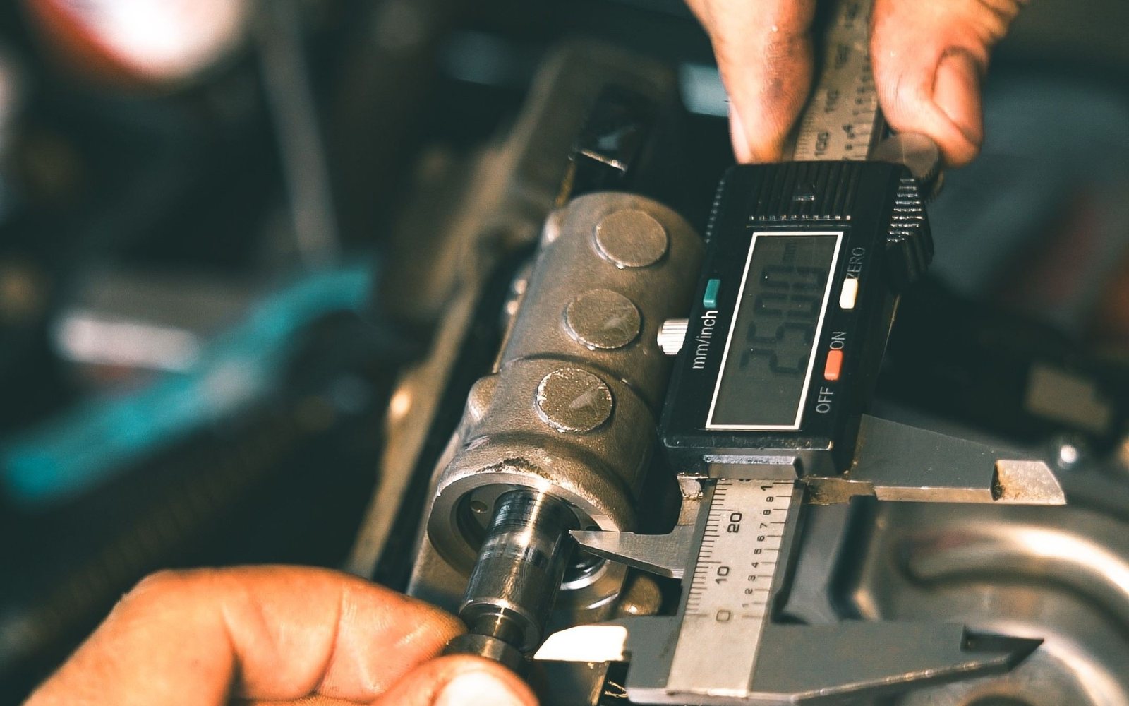 Measuring a sample part with a digital caliper during the initial consultation